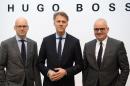 (L-R) Mark Langer, Claus-Dietrich Lahrs (chairman) and Christoph Auhagen, members of the board of German fashion house Hugo Boss, arrive for the annual press conference at the company's headquarter in Metzingen, southern Germany on March 14, 2013