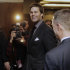 New England Patriots quarterback Tom Brady talks to a friend as he leaves a news conference on Sunday, Jan. 29, 2012, in Indianapolis. The Patriots are scheduled to face the New York Giants in Super Bowl XLVI on Feb. 5. (AP Photo/Mark Humphrey)