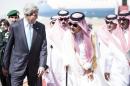 US Secretary of State John Kerry (L) and Saudi Foreign Minister Prince Saud al-Faisal (C) on June 27, 2014 at King Abdulaziz International Airport in the Saudi city of Jeddah