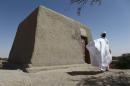 Sane Chirfi, representing the family which looks after the mausoleum of Alpha Moya, poses in front of the mausoleum on February 4, 2016 Timbuktu