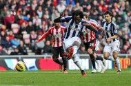 West Bromwich Albion's Romelu Lukaku, center, scores his goal from a penalty kick during their English Premier League soccer match against Sunderland at the Stadium of Light, Sunderland, England, Saturday, Nov. 24, 2012. (AP Photo/Scott Heppell)