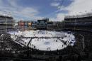 Fans wait for the start of an outdoor NHL hockey game between the New Jersey Devils and the New York Rangers Sunday, Jan. 26, 2014, at Yankee Stadium in New York. (AP Photo/Frank Franklin II)