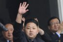 North Korea leader Kim Jong-un waves to soldiers and civilians during a ceremony in Pyongyang