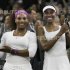 Venus Williams of the U.S. and Serena Williams of the U.S. hold their trophies after defeating Andrea Hlavackova of the Czech Republic and Lucie Hradecka of the Czech Republic in their doubles tennis match at the Wimbledon tennis championships in London