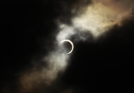 An annular solar eclipse is seen briefly during a break in clouds over Taipei, Taiwan, Monday, May 21, 2012. The annular solar eclipse, in which the moon passes in front of the sun leaving only a golden ring around its edges, was visible to wide areas across the continent Monday morning. (AP Photo/Wally Santana)