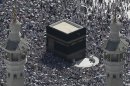 This aerial image made from a helicopter shows tens of thousands of Muslim pilgrims moving around the Kaaba, the black cube seen at center, inside the Grand Mosque, during the annual Hajj in the Saudi holy city of Mecca, Saudi Arabia, Saturday, Oct. 27, 2012. (AP Photo/Hassan Ammar)