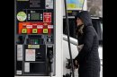 In this Wednesday, Feb. 27, 2013 photo, a woman fills up a gas tank at a gas station in Chicago. A measure of wholesale prices fell by the largest amount in 10 months in March, reflecting a big drop gasoline prices. The Labor Department, on Friday, April 12, 2013, says its producer price index fell 0.6 percent in March compared with February. In February, wholesale prices had jumped 0.7 percent. (AP Photo/Nam Y. Huh)