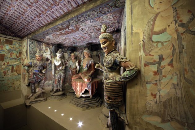 A full scale replica cave from the 8th century that contains the Bodhisattva of the Mogao Caves is presented in "Dunhuang: Buddhist Art at the Gateway of the Silk Road," at the China Institute, in New York, Tuesday, April 24, 2013. (AP Photo/Richard Drew)
