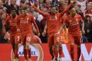 Liverpool's striker Daniel Sturridge (C) celebrates after scoring his team's second goal during the UEFA Europa League semi-final second leg football match between Liverpool and Villarreal CF in Liverpool, England on May 5, 2016