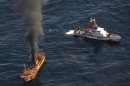 In this photo provided by the U.S. Coast Guard, a plume of smoke rises from a derelict Japanese ship after it was hit by canon fire by a U.S. Coast Guard cutter on Thursday, April 5, 2012, in the Gulf of Alaska. The Coast Guard decided to sink the ship dislodged by last year's tsunami because it was a threat to maritime traffic and could have an environmental impact if it grounded. (AP Photo/U.S. Coast Guard, Petty Officer 2nd Class Charly Hengen)