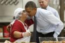 U.S. President Barack Obama greets a worker as he tours Costco Wholesale in Woodmore Towne Centre in Lanham