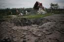 Buildings damaged by a recent shelling are seen in the eastern Ukrainian village of Semenovka