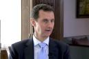 Syrian President Bashar al-Assad speaks during a TV interview in Damascus