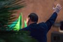 Italy's former prime minister Silvio Berlusconi waves during his speech outside his private residence, the Palazzo Grazioli, on November 27, 2013 in Rome