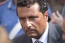Captain Francesco Schettino leaves the court room of the converted Teatro Moderno theater at the end of a hearing of his trial, in Grosseto, Italy, Thursday, July 18, 2013. The trial of the captain of the shipwrecked Costa Concordia cruise liner, accused of multiple manslaughter, abandoning ship and causing the shipwreck near the island of Giglio, is being held in a theater converted into a courtroom in Tuscany to accommodate all the survivors and relatives of the 32 victims who want to see justice carried out in the 2012 tragedy. (AP Photo/Andrew Medichini)