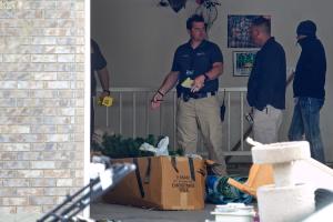 Authorities investigate a crime scene at a house in&nbsp;&hellip;