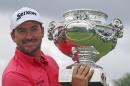Graeme McDowell of Northern Ireland poses with his trophy after winning the French Open Golf tournament at Paris National course in Guyancourt, west of Paris, France, Sunday, July 6, 2014. (AP Photo/Francois Mori)