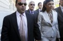 Giuseppe "Joe" Giudice, 43, left, and his wife, Teresa Giudice, 41, of Montville Township, N.J., walk out of Martin Luther King, Jr. Courthouse after a court appearance, Tuesday, July 30, 2013, in Newark, N.J. The two stars of the "Real Housewives of New Jersey" were indicted Monday on federal fraud charges, accused of exaggerating their income while applying for loans before their TV show debuted in 2009, then hiding their improving fortunes in a bankruptcy filing after their first season aired. They are charged in a 39-count indictment with conspiracy to commit mail and wire fraud, bank fraud, making false statements on loan applications and bankruptcy fraud. (AP Photo/Julio Cortez)
