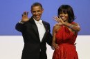 FILE - In this Jan. 21, 2013, file photo, President Barack Obama and Michelle Obama wave to guests after their dance at the Inaugural Ball at the 57th Presidential Inauguration in Washington. Michelle Obama has a new look, both in person and online, and with the president's re-election, she has four more years as first lady, too. The first lady is trying to figure out what comes next for this self-described "mom in chief" who also is a champion of healthier eating, an advocate for military families, a fitness buff and the best-selling author of a book about her White House garden. For certain, she'll press ahead with her well-publicized efforts to reduce childhood obesity and rally the country around its service members. (AP Photo/Paul Sancya, File)