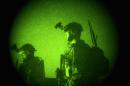 FILE - In this Thursday, Oct. 29, 2009 file photo taken with a night vision scope, U.S. Special Operations forces engage in a joint operation with Afghan National Army soldiers targeting insurgents operating in Afghanistan's Farah province. Afghan President Ashraf Ghani has ordered a top-to-bottom review of the practices of the country's defense forces, including discussing a possible resumption of controversial night raids banned by his predecessor, the Associated Press has learned. The move appears aimed at revamping the military for the fight against the Taliban amid new indications that U.S. and international forces will play a greater role than initially envisaged. (AP Photo/Maya Alleruzzo, File)