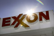 <p>               FILE - This Oct. 26, 2006, file photo shows an Exxon logo at a gas station in Dallas. Exxon Mobil said Thursday, April 26, 2012, that it earned $9.45 billion, or $2 per share, in the first quarter, down from $10.7 billion, or $2.14, a year earlier. Revenue rose 8.8 percent to $124.1 billion. (AP Photo/LM Otero, File)
