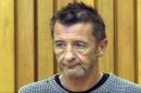 This still frame grab taken on November 6, 2014 and provided by TVNZ shows the drummer with legendary rock band AC/DC, Phil Rudd, attending a court hearing in Tauranga, New Zealand