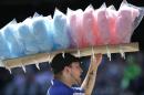 FILE - In this Sept. 8, 2013 file photo, a vendor sells cotton candy at Safeco field during a baseball game between the Tampa Bay Rays and the Seattle Mariners, in Seattle. A new study published Monday, Feb. 3, 2014 in the journal, JAMA Internal Medicine, says diets high in sugar are linked with increased risks for fatal heart disease, and it doesn't take that much extra sugar to boost the risk, anything more than a 20-ounce Mountain Dew soda a day. (AP Photo/Ted S. Warren,File)
