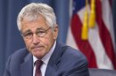 Defense Secretary Chuck Hagel pauses during a news conference at the Pentagon, Wednesday, July 31, 2013. Hagel warned that the Pentagon may have to mothball up to three Navy aircraft carriers and order more sharp reductions in the size of the Army and Marine Corps if Congress does not act to avoid massive budget cuts beginning in 2014. (AP Photo/Evan Vucci)
