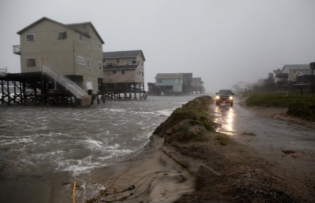Abandoned beach front houses are surrounded by rising water as the effects of Hurricane Irene are felt in Nags Head, N.C., Saturday, Aug. 27, 2011 (AP Photo/Gerry Broome)