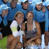 Russia's Svetlana Kuznetsova, left,  and compatriot Vera Zvonareva, right, pose with the trophy, surrounded by ball boys after winning their women's doubles final against Italy's Sara Errani and Roberta Vinci at the Australian Open tennis championship, in Melbourne, Australia, Friday, Jan. 27, 2012. (AP Photo/Sarah Ivey)
