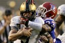 Army quarterback Angel Santiago (3) is dragged down by the helmet by Louisiana Tech safety Thomas McDonald (33) just shy of the end zone on a quarterback keeper in the second half of an NCAA college football game, Saturday, Sept. 28, 2013, in Dallas. Army won 35-16. (AP Photo/Tony Gutierrez)