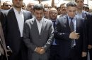 Iranian President Mahmoud Ahmadinejad, center, reacts during his visit to the Imam Ali shrine in Najaf, Iraq, Friday, July 19, 2013. The outgoing Iranian president's visits to the cities of Najaf and Karbala during the Islamic holy month of Ramadan followed meetings with top Iraqi officials in Baghdad on Thursday that highlighted the tightening bonds between Shiite-led Iraq and Iran. (AP Photo/Karim Kadim, Pool)