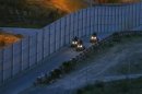 U.S. Border Patrol agents patrol along the international border between Mexico and the United States near San Diego