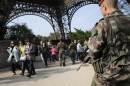 Soldiers patrol at the Eiffel Tower in Paris, France, Tuesday, Sept. 23, 2014. Frenchman Herve Gourdel, 55, was abducted in Algeria on Monday by a splinter group from al-Qaida's North African branch. The Jund al-Khilafah, or Soldiers of the Caliphate, said it would kill him unless France halts it airstrikes in Iraq within 24 hours. French forces on Friday joined the U.S. in carrying out airstrikes against extremists who have overrun large areas of Syria and Iraq. (AP Photo/Christophe Ena)
