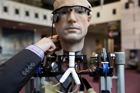 An engineer makes an adjustment to the robot "The Incredible Bionic Man" at the Smithsonian National Air and Space Museum in Washington October 17, 2013. REUTERS/Joshua Roberts