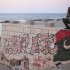 Painter Rafat Askar, 46, rests at the seaside of the rebel-held town of Benghazi, Libya, Thursday, Aug. 18, 2011. The paint on the wall reads: "Libya Free." (AP Photo/Alexandre Meneghini)