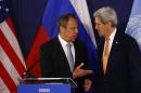 Russian Foreign Minister Lavrov speaks to U.S. Secretary of State Kerry before their news conference in Vienna