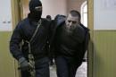 Tamerlan Eskerkhanov, detained over the killing of Boris Nemtsov, is escorted inside a court building in Moscow