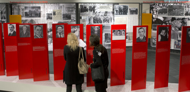 Two women look at exhibits of the 'Berlin 1933 - the way to despotism' exhibition at the Topography of Terror museum in Berlin, Germany, Wednesday, Jan. 30, 2013. The Topography of Terror museum is located at the area where the headquarters of the Gestapo and SS were destroyed by allied bombing. (AP Photo/Michael Sohn)