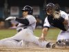 Seattle Mariners catcher Miguel Olivo, right, follows through after tagging out New York Yankees' Andruw Jones at home in the third inning of a baseball game Wednesday, Sept. 14, 2011, in Seattle. (AP Photo/Elaine Thompson)