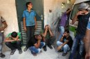Palestinians mourn outside hospital in central Gaza Strip after an Israeli air strike