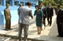 In this photo released by the South Korean Unification Ministry, Kim Song Hye, center, the head of North Korea's delegation, shakes hands with an unidentified South Korean officer before crossing a military demarcation line, which has separated the two Koreas since the Korean War, for a meeting with South Korean delegates at Panmunjom in Paju, north of Seoul, South Korea, Sunday, June 9, 2013. Government delegates from North and South Korea began preparatory talks Sunday at the "truce village" on their heavily armed border aimed at setting ground rules for a higher-level discussion on easing animosity and restoring stalled rapprochement projects. (AP Photo/South Korean Unification Ministry, HO)