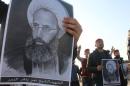 Shi'ite Muslims hold pictures of Shi'ite Muslim cleric Nimr al-Nimr during a protest against his execution in Saudi Arabia, in Basra