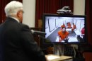 Former NFL quarterback Ryan Leaf makes an initial court appearance before Cascade County District Judge Dirk Sandefur via video link as his defense attorney, Eric Olson, listens at left, Monday, April 2, 2012, in Great Falls, Mont. Leaf was arrested again on Monday and is accused of committing another burglary two days after he posted bail on charges that he broke into a friend's home and stole prescription painkillers, a drug task force commander said. (AP Photo/The Great Falls Tribune, Larry Beckner) NO SALES