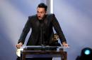 Cedric Gervais accepts the best remixed recordings, non-classical award for "Summertime Sadness" at the pre-telecast of the 56th annual GRAMMY Awards on Sunday, Jan. 26, 2014, in Los Angeles. (Photo by Matt Sayles/Invision/AP)