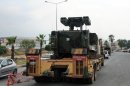 In this photo taken Wednesday, June 27, 2012, a Turkish military truck transports a mobile missile launcher to the Syrian border, in Iskenderun, Turkey. Turkey is deploys antiaircraft units along its border with Syria following the downing of one of its warplanes by Syrians.(AP Photo)