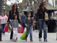 <p>               In this April 24, 2012, file photo, women and girls carry purchases on the Third Street Promenade in Santa Monica, Calif. The Commerce Department said Friday, April 27, 2012, that the economy expanded at an annual rate of 2.2 percent in the January-March quarter, compared with a 3 percent gain in the final quarter of 2011. Consumers spent at the fastest pace in more than a year. (AP Photo/Reed Saxon, File)