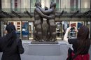 Botero's "Dancers" is photographed by a passer-by as it sits in front of Christie's Auction House in New York