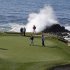 Brandt Snedeker, left, lines up his putt as waves crash behind the seventh green of the Pebble Beach Golf Links during the third round of the AT&T Pebble Beach Pro-Am golf tournament  Saturday, Feb. 9, 2013 in Pebble Beach, Calif. (AP Photo/Eric Risberg)