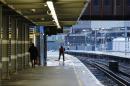 A man sweeps an empty platform at Waterloo Station after numerous trains were cancelled due to storms in London